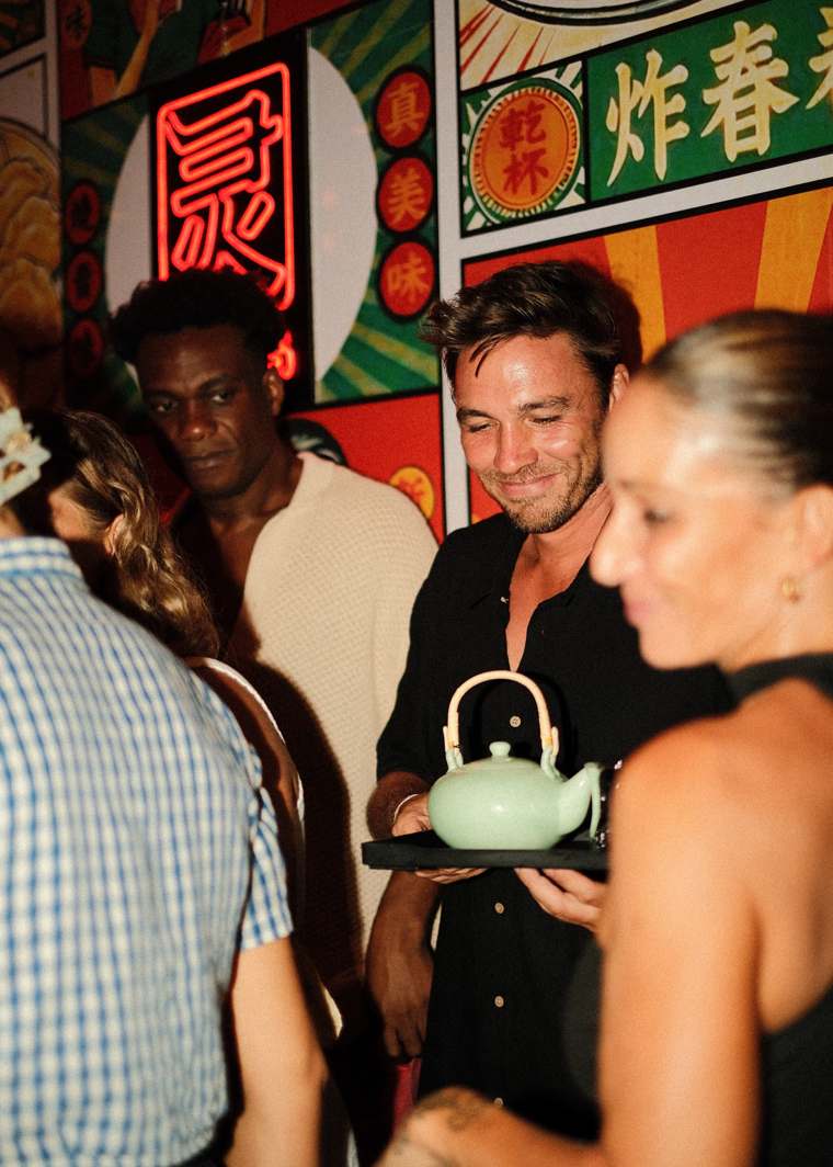A teapot being carried through the crowd