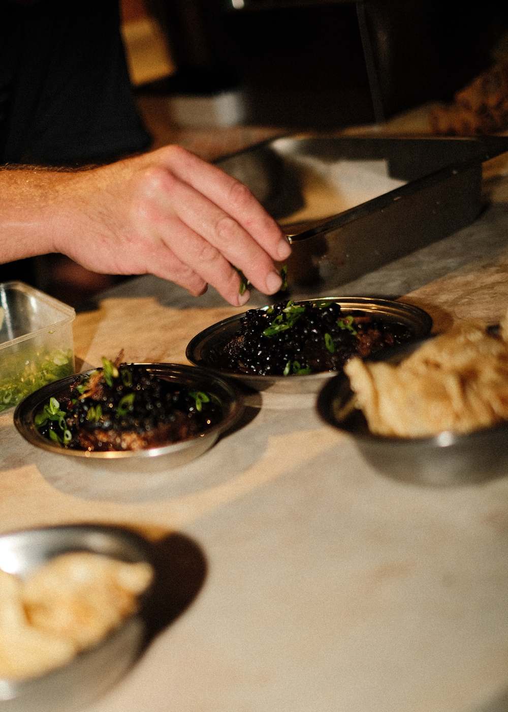 Garnishing plates on the pass