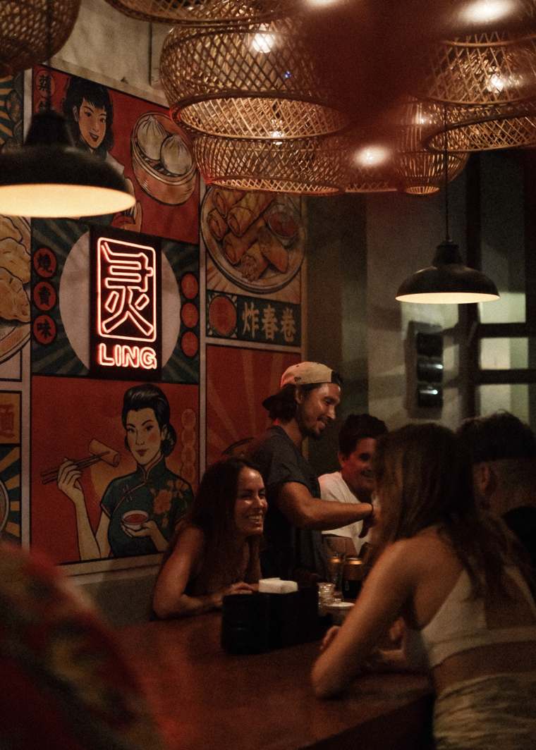 The neon 灵 sign over the bar